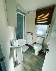a bathroom with a white sink and a toilet at Twilight Escape in Swarland