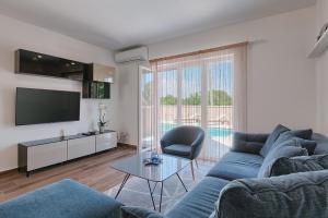 TV a/nebo společenská místnost v ubytování Villa Mokka - Perfekt ausgestattete Villa in hervorragender Lage