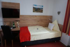 Postel nebo postele na pokoji v ubytování Hotel Jan van Werth