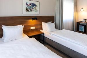 a hotel room with two beds and a window at Hotel Santin in Bełchatów +55 photos