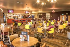 a restaurant with tables and chairs and a bar at Beaches45 in Hythe