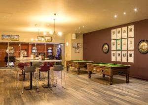 a room with two pool tables and a bar at Beaches45 in Hythe