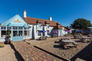 a restaurant with picnic tables in front of it at Beaches45 in Hythe