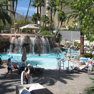 a swimming pool with a waterfall in a resort at MGM Signature studio No resort fee in Las Vegas