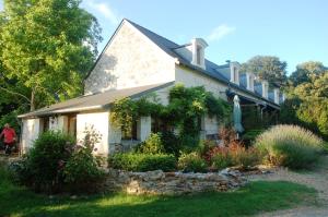 a white house with a garden in front of it at Le Logis du Pressoir Self Catering Gites in beautiful 18th Century Estate in the heart of the Loire Valley with heated pool and extensive grounds. in Brion