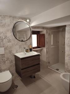 a bathroom with a sink and a toilet and a mirror at L'OLIVA CONTESA - la BIANCA in Gaeta