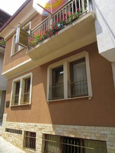 a building with a balcony with flowers on it at Apartments Stars in Ohrid