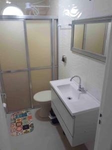 a bathroom with a sink and a toilet at Apto excelente à 50m do parque de águas termais in Piratuba