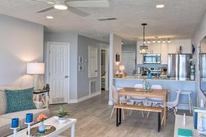 a living room and kitchen with a table and a couch at Ocean-View Balcony: Family Gem on Seawall Blvd! in Galveston