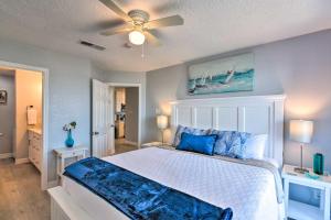 a bedroom with a bed and a ceiling fan at Ocean-View Balcony: Family Gem on Seawall Blvd! in Galveston