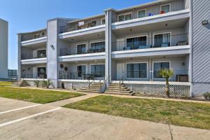 an apartment building with stairs in front of it at Ocean-View Balcony: Family Gem on Seawall Blvd! in Galveston