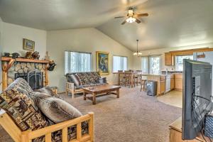 a living room with a couch and a fireplace at Big Bear Lake Cabin with Deck and Views about 9 Mi to Ski! in Baldwin Lake