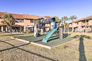 een speeltuin met een glijbaan in een tuin bij Sun-Dappled PCB Retreat with Multiple Pools! in Panama City Beach