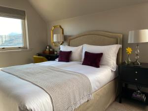 a bedroom with a large white bed with two pillows at Ardvreck House in Ullapool