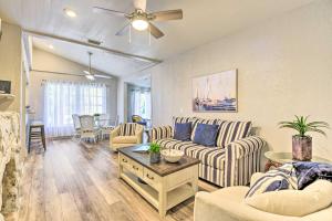 a living room with couches and a ceiling fan at Port Charlotte Cottage about 3 Mi to Beach Park! in Port Charlotte