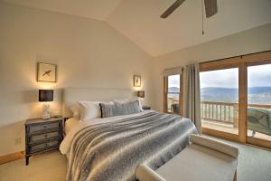 a bedroom with a large bed and a balcony at Bright Sapphire Escape Near Hiking and Golfing! in Sapphire