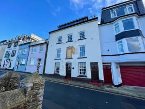 a row of white houses on a city street at Sampford Harbour Side Guest House in Brixham