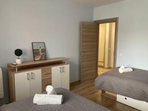 a small bedroom with two beds and a mirror at Victor's Suite , with private parking in Varna City