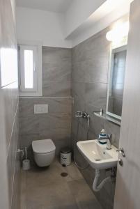 a bathroom with a toilet and a sink at Nissea Apartments in Naxos Chora +19 photos