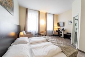 a hotel room with a bed and a desk at Galerie Hotel in Bad Reichenhall