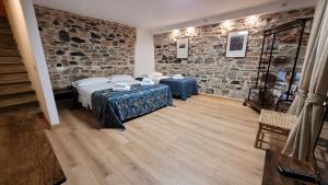 a room with two beds and a stone wall at Soggiorno Madrid in Florence
