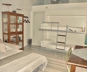 a bedroom with two bunk beds and a table at Albarola in Monterosso al Mare