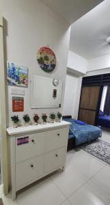 ein Zimmer mit einer Kommode mit Topfpflanzen darauf in der Unterkunft Hannah suite at cameronfair in Cameron Highlands