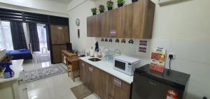 a kitchen with a sink and a microwave at Hannah suite at cameronfair in Cameron Highlands
