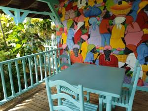 a bench on a deck with a mosaic wall at Las Palmas Eco Residence in Las Terrenas