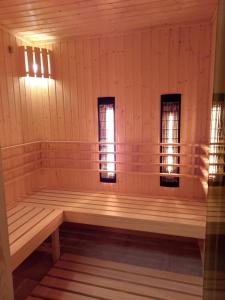 a sauna with two windows and a wooden bench at TatrApart in Zakopane