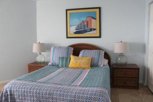 a bedroom with a bed with a blue comforter and two lamps at Ocean view, 2BR, 2BA Condo, St Regis 3213, Topsail, NC in North Topsail Beach +37 photos