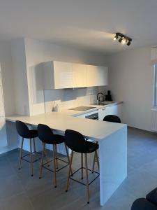 a kitchen with a table and four chairs at New appartement centre de Spa avec parking privé in Spa