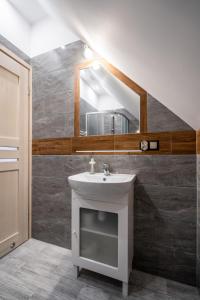 a bathroom with a sink and a mirror at Domek u Świerków in Chochołów