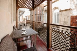 a balcony with a table and chairs on a balcony at Sazeli Boutique Hotel in Baku