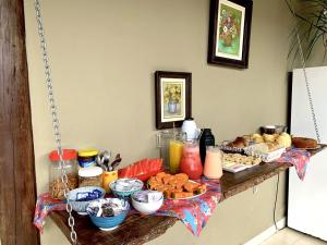 a table with a bunch of food on it at Pousada Casa Guntzel in Juquei