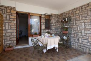 a table in a room with a stone wall at Un Ospite a Fontania in Gaeta