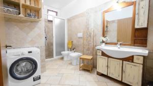 ein Badezimmer mit einer Waschmaschine und einem Waschbecken in der Unterkunft Villa La Tricasina by HDSalento in Tricase