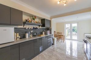 a kitchen with gray cabinets and a counter top at millennium stadium guest house in Cardiff +1 photo