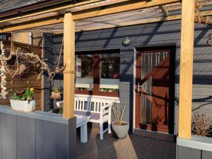 a blue shed with a bench and a wooden door at Ferienwohnung in Kappeln in Kappeln
