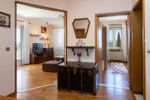 a living room with a table and a mirror at Apartments Villa Falkoni in Dubrovnik