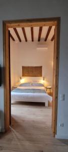 a bedroom with a large bed with a wooden frame at CAN LLAVI - LLAUT in Canet de Mar