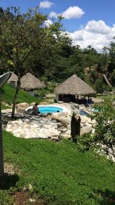 a person sitting in a chair next to a swimming pool at AMUNTAI RAINFOREST LODGE in Palora