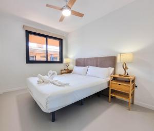 a bedroom with a white bed and a window at Relax in Paraiso by Olax Rentals in Playa Paraiso +27 photos