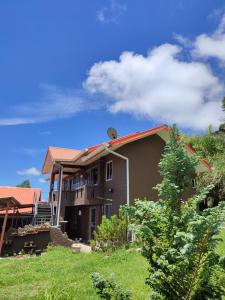 a house on a hill with a blue sky at Sinurambi 2 in Kampong Kundassan