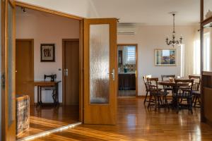a living room with a table and a wooden door at Apartments Villa Falkoni in Dubrovnik
