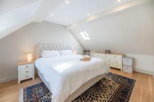 a bedroom with a large white bed and two night stands at Little Cottage Wickham Market Air Manage Suffolk in Woodbridge