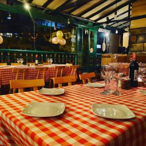 a table in a restaurant with a red and white checkered table cloth at Hotel Calicanto Real Cafe Museo in Monguí