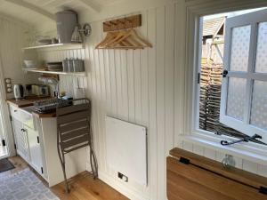 a small kitchen with a counter and a window at The Hut by the River in York
