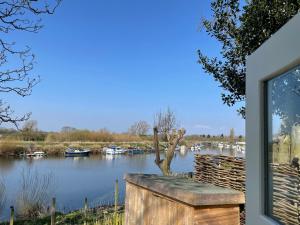 a view from a window of a river with boats at The Hut by the River in York