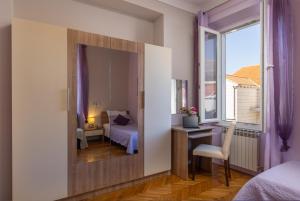 a room with a mirror and a bedroom with a bed at Villa Falkoni II in Dubrovnik